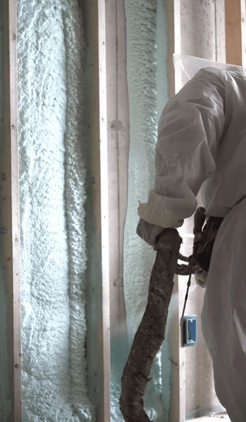 Closed-cell spray foam insulation being applied to a wall