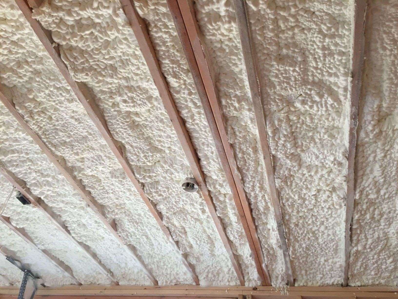 Open-cell spray foam insulation installed between roof joists